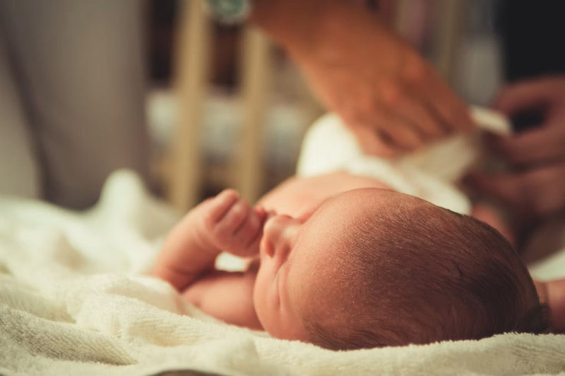 Nyfødt baby, der sover på et blødt tæppe